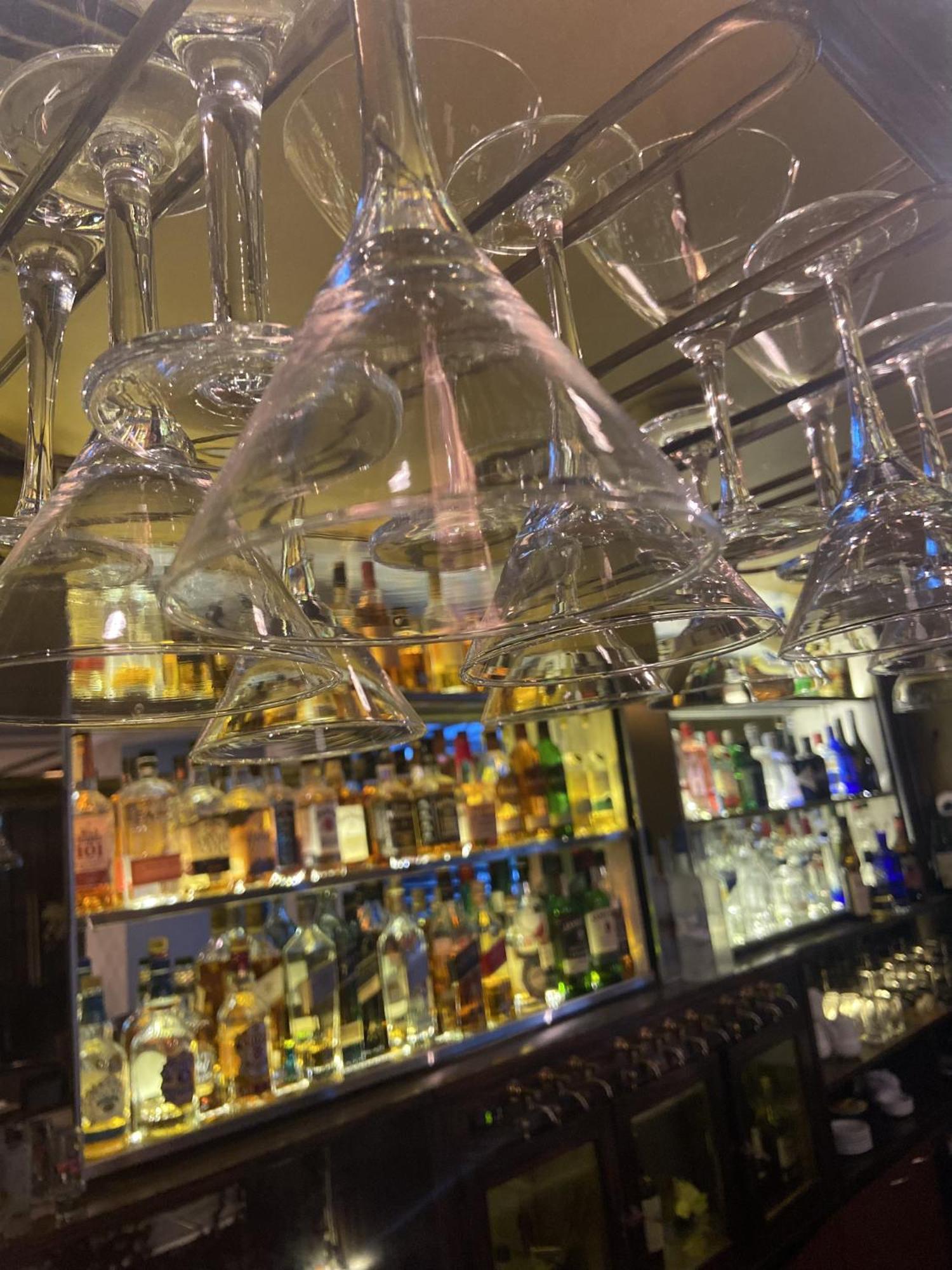 ホテル リーガル パシフィック プエルト マデロ ブエノスアイレス エクステリア 写真 Wine glasses hanging above a bar